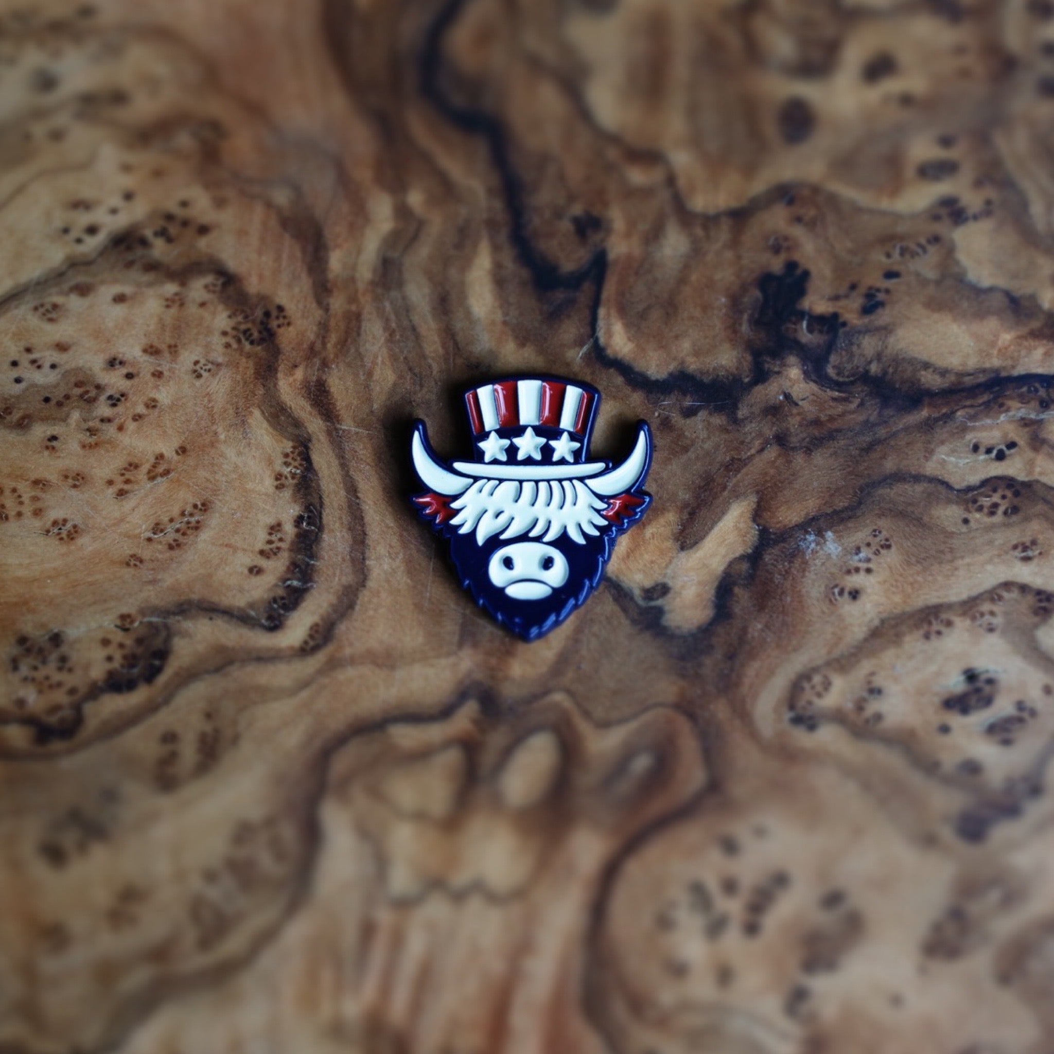 The Founder Ball Marker featuring Uncle Sam Looper artwork from The Founders Collection displayed on natural wood grain surface