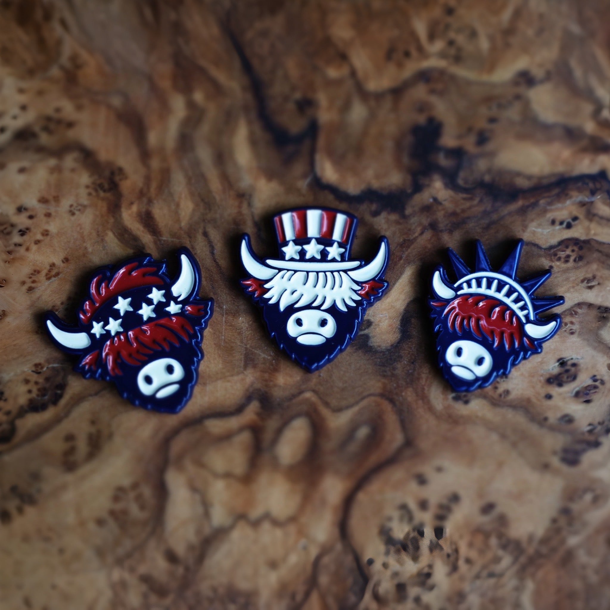 Americana-inspired golf ball markers from The Founders Collection by Caddy Collective Culture displayed on natural wood surface