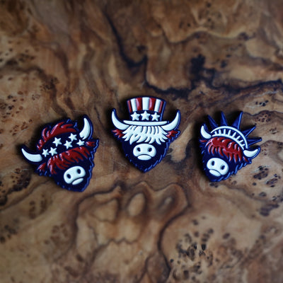 Americana-inspired golf ball markers from The Founders Collection by Caddy Collective Culture displayed on natural wood surface