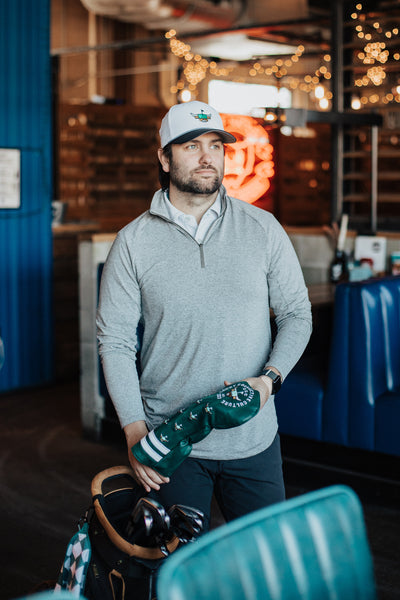 Caddy Collective two tone rope golf hat featuring Highlands Cattle Looper logo – front view with model
