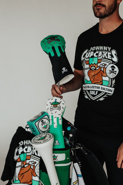 Johnny Cupcakes x Caddy Collective Culture golf collection full set including headcovers, divot tool, ball marker, towel, and t-shirt displayed in golf bag.