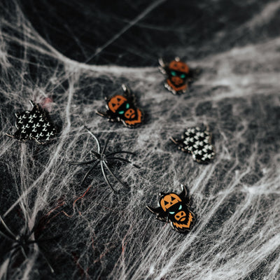 Looper After Dark ball markers displayed on spiderweb Halloween background with black spider