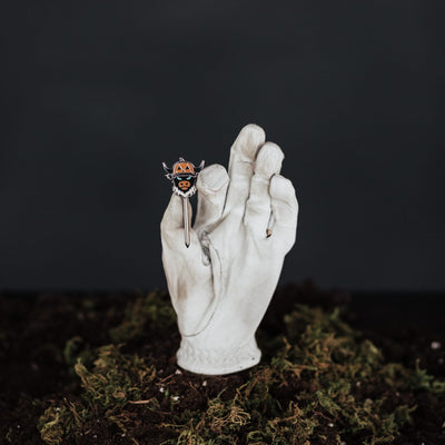 Looper After Dark combo tool held in hand showing black metal finish and pumpkin Looper design