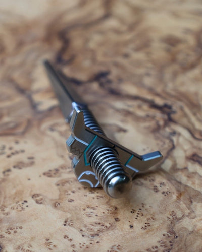 Looper Threaded Divot Tool displayed on olive wood highlighting handcrafted stainless steel construction.
