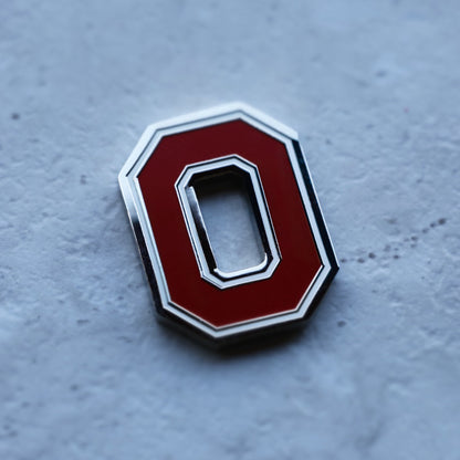 Angled view of Ohio State Block O ball marker showing metal edge detail