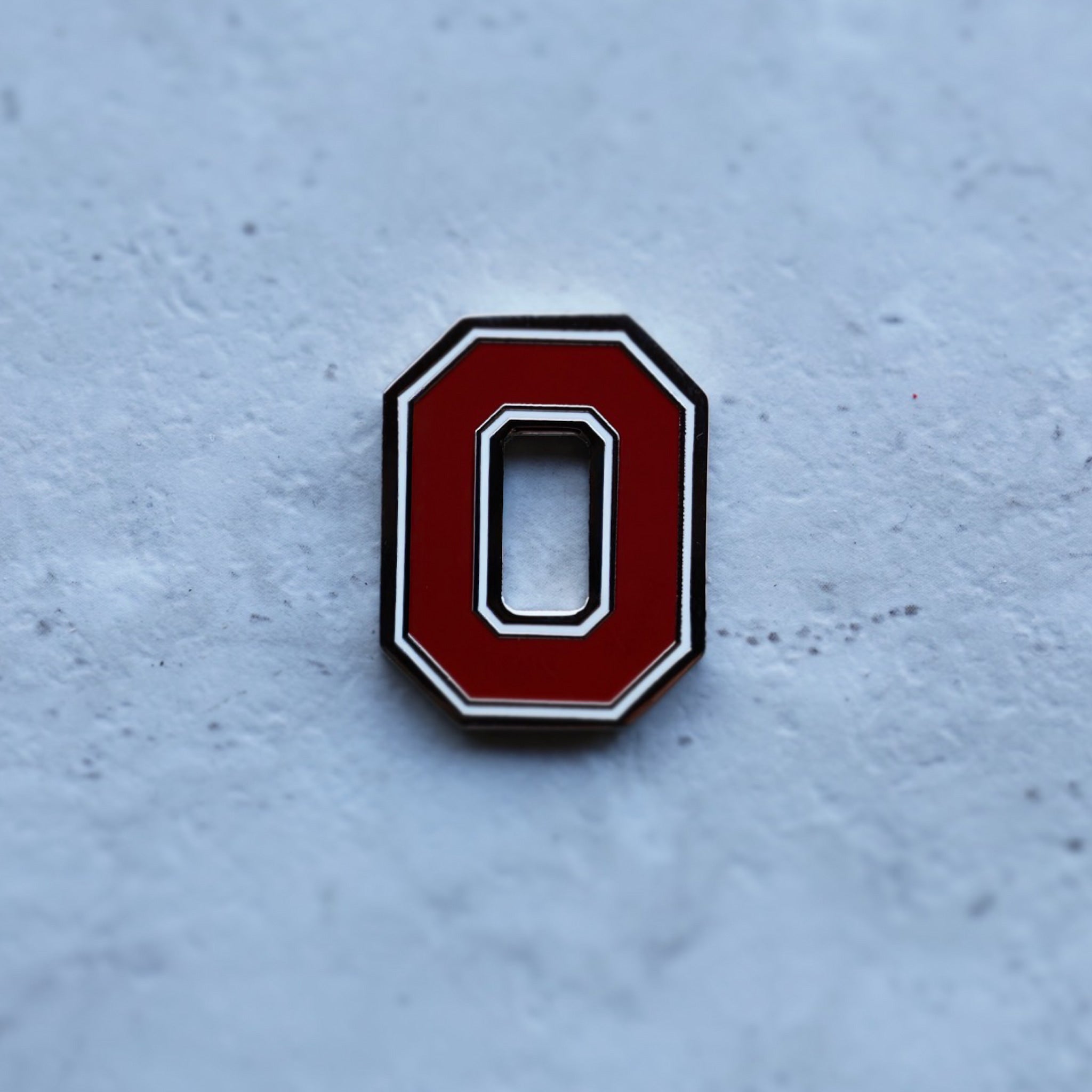 Close-up detail of Ohio State Block O golf ball marker