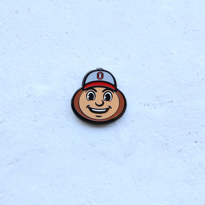 Ohio State Brutus Head golf ball marker photographed on textured surface