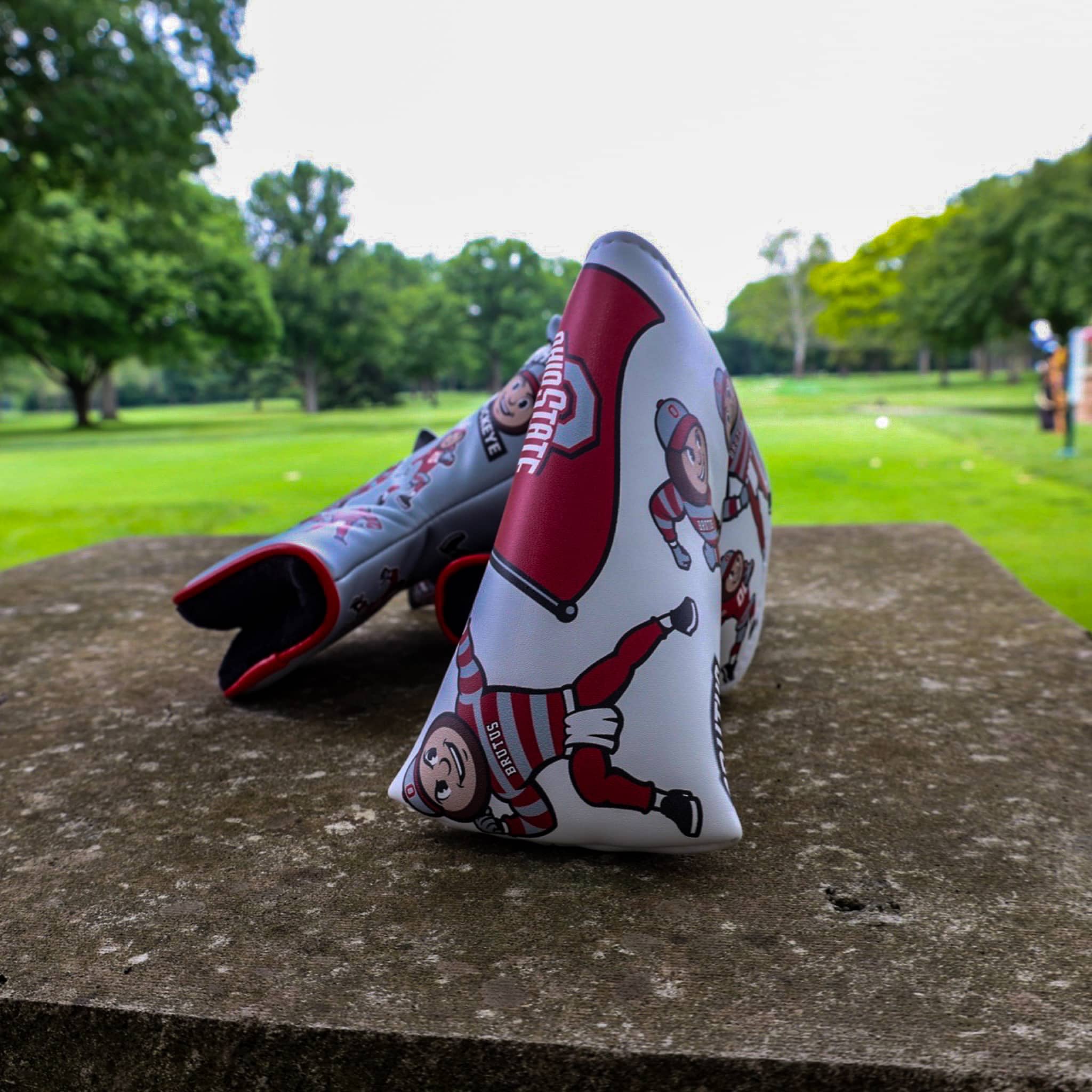 Close-up of the Ohio State Brutus blade putter headcover featuring repeating Brutus Buckeye graphics and official Ohio State branding.