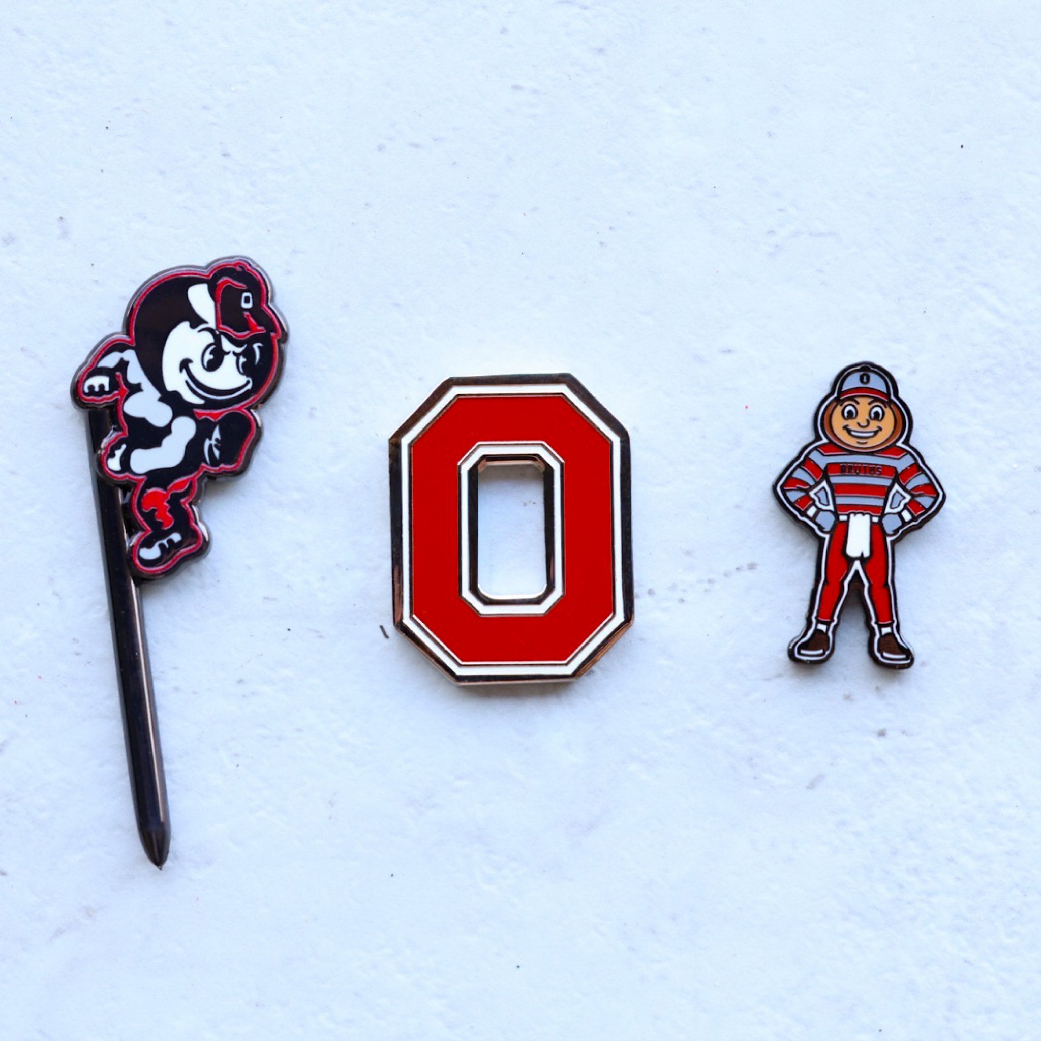 Ohio State Heritage Brutus divot tool shown with Ohio State golf accessories
