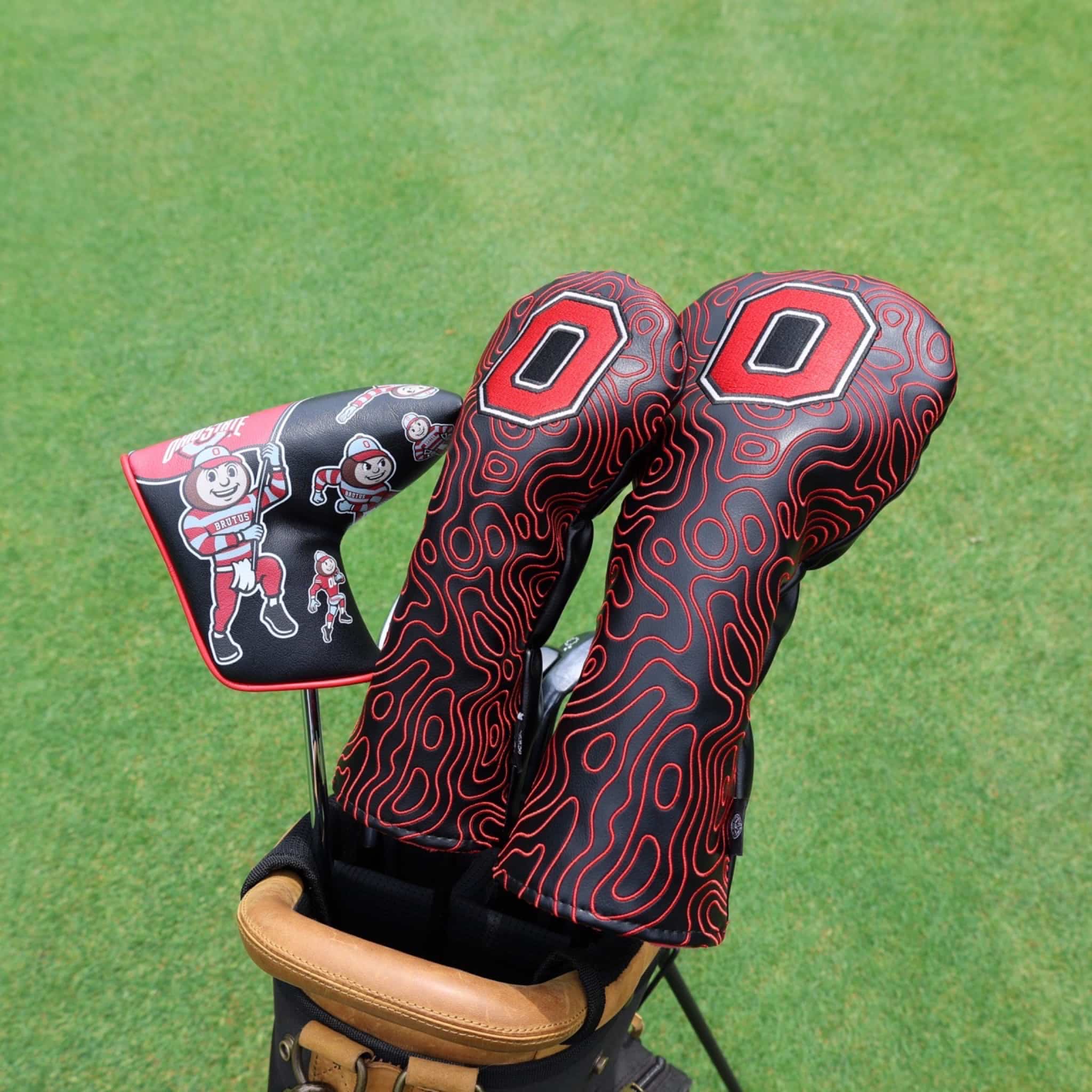 Ohio State golf headcovers and Brutus putter cover displayed in a golf bag featuring officially licensed Buckeyes golf accessories.
