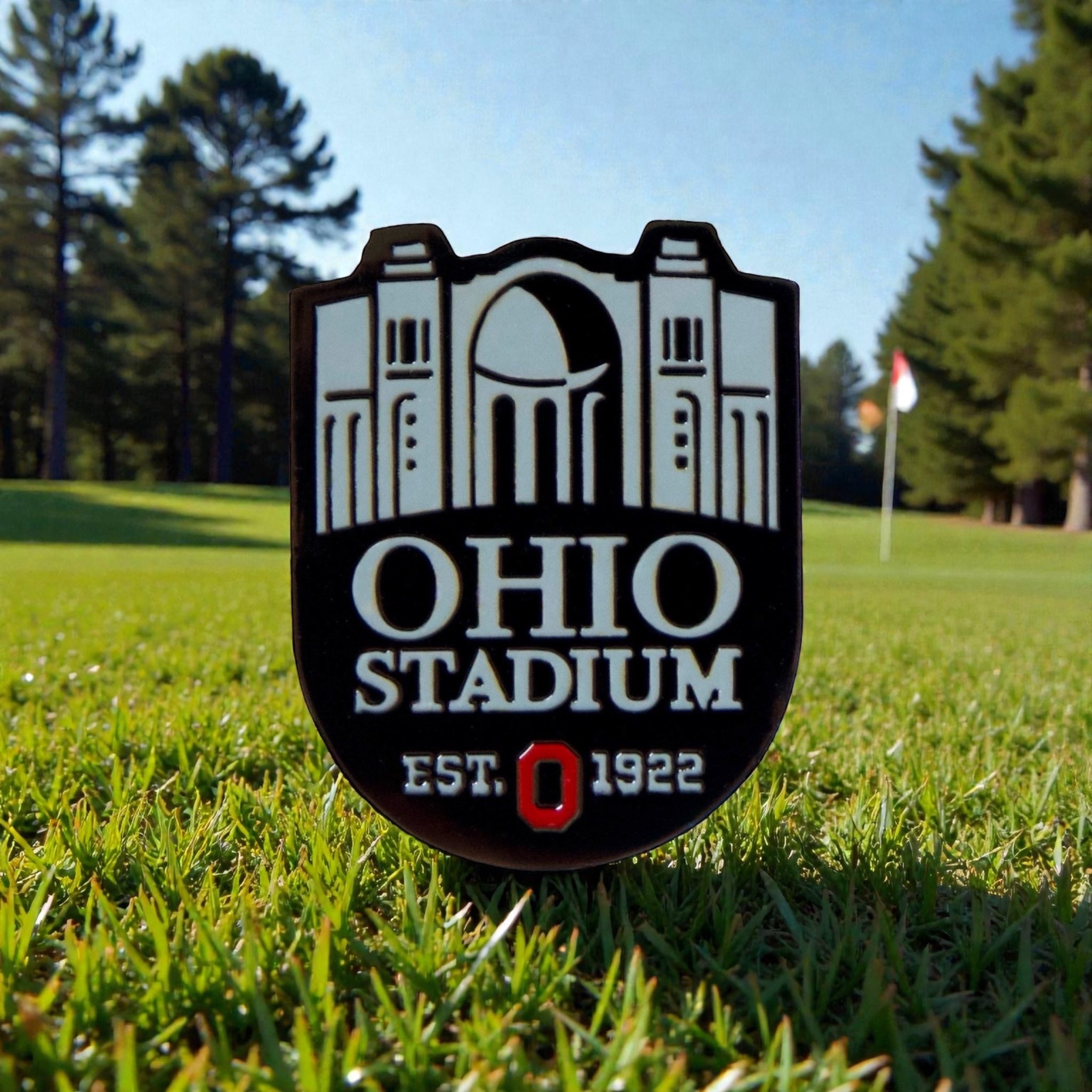 Ohio State THE Horseshoe Ball Marker featuring Ohio Stadium shield design displayed on putting green with flag in background