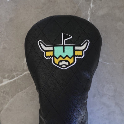 Quilted Heritage Leather Driver Headcover displayed against a stone backdrop, showcasing premium black quilted leather and luxury golf styling.