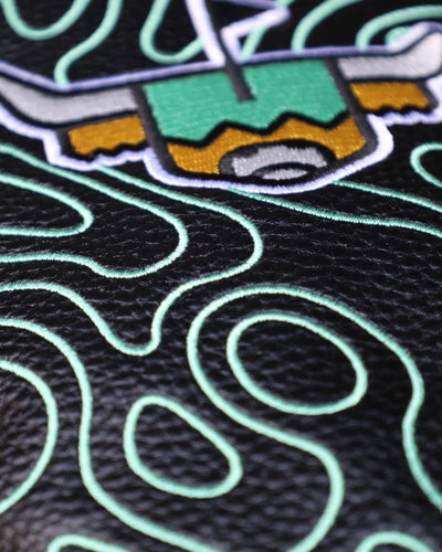 Close-up of the Terrain Driver Headcover – Midnight highlighting the embroidered green topographic pattern on black pebbled leather.
