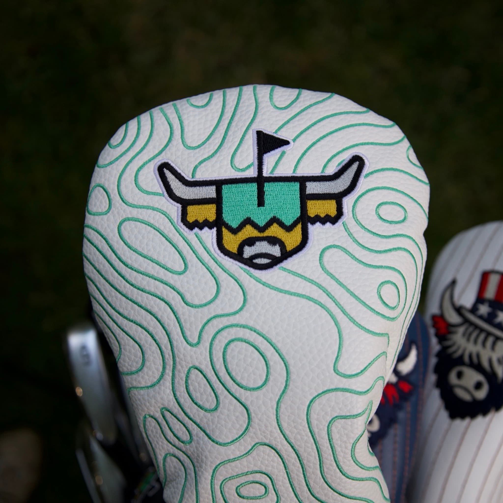 Terrain Driver Headcover displayed on a golf bag during a round, featuring embroidered topographic detailing.