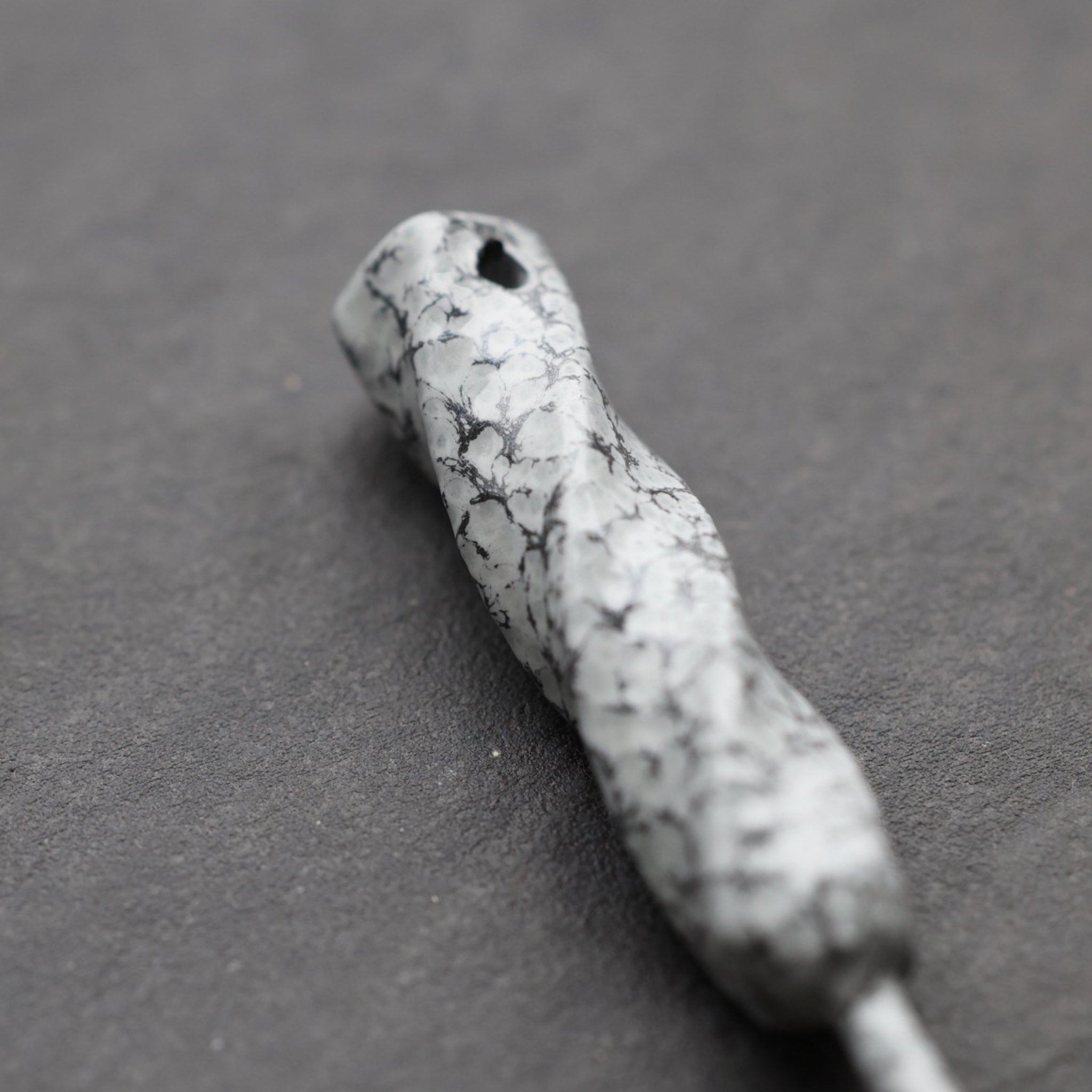 Close-up of Twisted Metal single prong divot tool in Palleon White finish highlighting organic forged texture