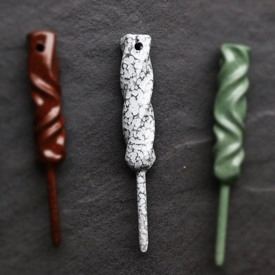 Three Twisted Metal single prong divot tools displayed together in rustic, Palleon White, and green finishes