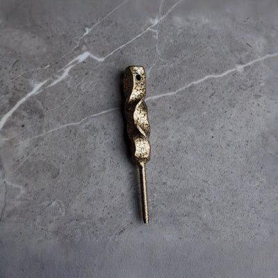 Front view of the Twisted Column Golf Divot Tool featuring a hand-forged twisted steel body with an antique gold finish.